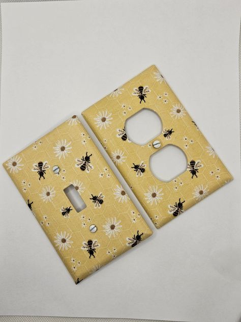 Bumble Bee & Flowers Light Switch and Outlet Covers.  Please view chart in the photos before ordering to ensure you are ordering the correct plate type.  All plates are individually wrapped and come with white head screws. The super cute Bumble Bee Light Switch Covers are the perfect accent to bring a room together.  Perfect for nurseries! These plates are mid-sized, other sizes available upon request.  Orders ship within 3-5 business days. Tracking will be available via USPS.  FREE SHIPPING on Bumble Bee Room Decor, Nursery Bumble Bee, Bug Themed Bedroom, Bee Themed Nursery Baby Rooms, Bee Theme Room, Bee Themed Nursery, Bumble Bee Kitchen, Bee Room Decor, Bee Bathroom