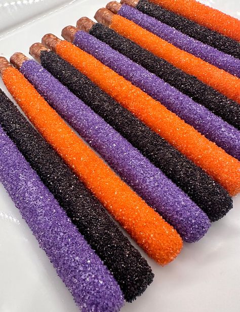 Halloween colored sugar Chocolate Covered pretzel rods crafted with black,orange and purple chocolate and coated with matching colored sugars. Made only when ordered so to insure a fresh and crunchy treat!   These are perfect for Trick-or-Treators or as favors for school or Halloween parties. The kids will really enjoy these treats!!  Do you think you might need more than 12? Then send me a convo and I will create a custom listing with the quantities you desire.  Each will come individually wrapped in a long clear pretzel sleeve tied with color coordinated ribbons.  Delightful Chocolates annoy be held responsible for melted or broken chocolate once the package has left our possession. We also cannot be responsible for how the postal service treats or handles the package. We take great prid Fall Pretzels, Fall Pretzel Rods, Chocolate Pretzels Halloween, Chocolate Covered Pretzel Rods Halloween, Chocolate Dipped Pretzels Halloween, Chocolate Dipped Pretzel Rods Halloween, Halloween Pretzel Rods, Halloween Pretzels Rods, Halloween School Party