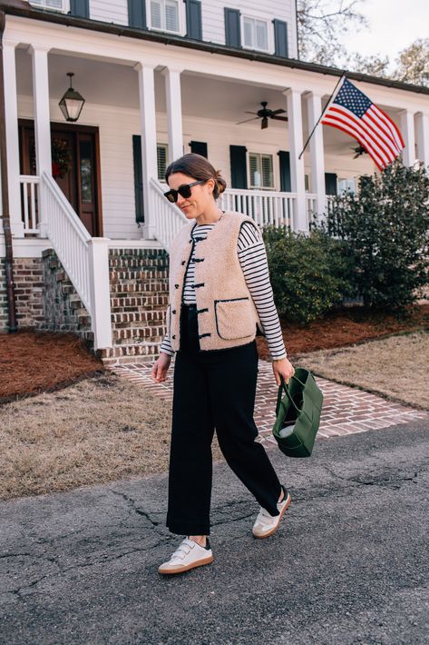 Liz Adams shares twelve wardrobe essentials for classic style in 2023, including the best striped shirt, white sneakers, leather tote bag, and more. Style In 2023, Liz Adams, Adams Family, Classic Cardigan, Striped Long Sleeve Shirt, Classic Dress, Daily Look, Light Jacket, Striped Tee