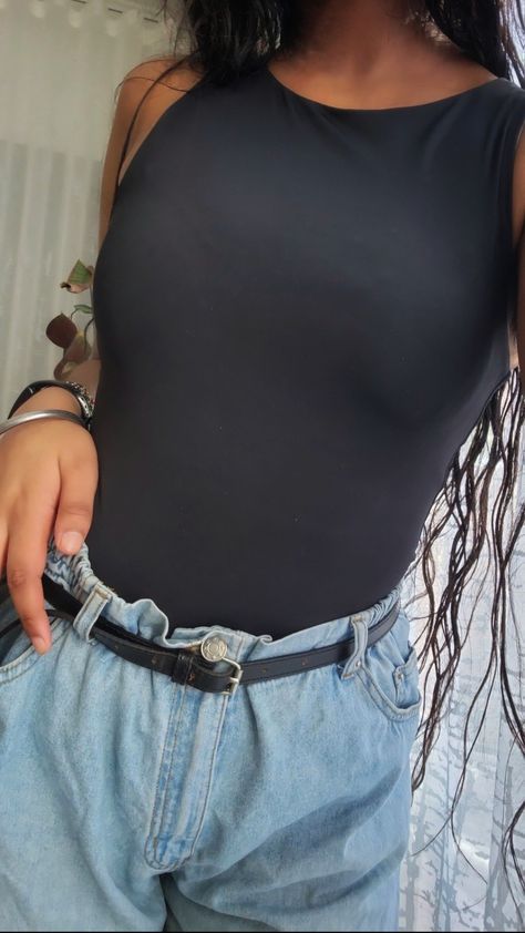 This is an outfit picture of a woman wearing a black sleavless mock neck body suit (a skims dupe if you will), with baggy light blue jeans and a thin black belt. Halter Neck Bodysuit, Uni Outfits, Halter Neck, Leotards, High Waisted, Tank Tops, Cute Outfits, Clothes