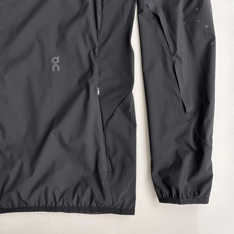 RUNNING JACKET PAF (BLACK) A timeless hooded running jacket updated for transitional seasons. Made from lightweight materials that deliver great ventilation and packability, it‘s the ideal protective layer for unexpected changes of weather. An abstract pattern of reflective dots offers improved safety in low-light conditions. Sports Track Jacket With Reflective Details, Sports Nylon Track Jacket With Reflective Details, Technical Track Jacket With Reflective Details For Outdoor, Technical Sports Windbreaker With Reflective Details, Technical Moisture-wicking Outerwear For Running, Men's Windbreaker, Running Jacket, Sports Design, Aston Martin