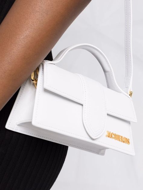 White leather Le Bambino Long shoulder bag from JACQUEMUS featuring foldover top, gold-tone hardware, adjustable shoulder strap, internal slip pocket, foldover top with magnetic fastening and gold-tone logo lettering. This item is in size UNI and the color is White Jaqmeous Bag, Jacquemus Le Bambino Long, Long Shoulder Bag, Bday Wishlist, Jacquemus Bag, Fancy Things, Mini Tote Bag, Pretty Bags, Mini Handbags