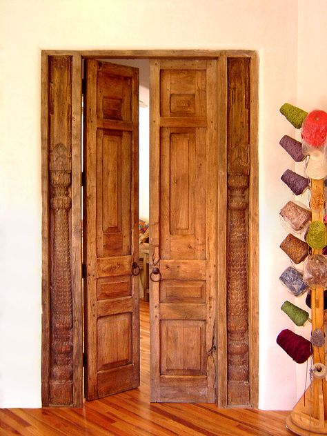 This antique door with columns surround is the bedroom entry to a Santa Fe casita. It was crafted using a pair of antique Mexican doors. Guest House Bedroom, Spanish Style Front Door, Spanish Doors, Mexican Doors, Rustic Doors Interior, Custom Exterior Doors, Double Door Entryway, Double Doors Exterior, Double Doors Interior