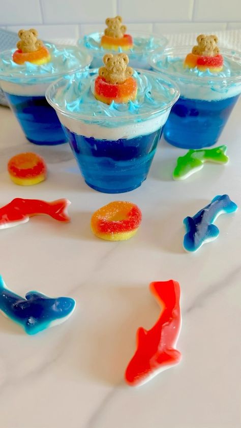 Frosted Little Pandas | 🛟🦈Jello Shark Cups🦈🛟 These yummy shark cups are simple to make and have a fun gummy shark surprise swimming in the Jello. 🦈 To make them… | Instagram Jello Pool Cups, Shark Week Snacks For Adults, Shark Week Desserts, Shark Jello Cups, Shark Week Snacks, Shark Jello, Shark Themed Snacks, Shark Themed Food, Blue Activities