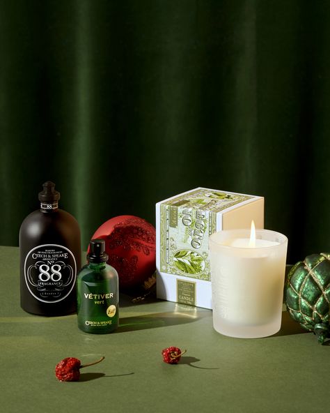 The classic No.88 Cologne Shaker alongside Vetiver Vert eau de Parfum and Perfecto Fino Candle on green with Christmas Baubles, red berries and a dark green velvet curtain behind. Christmas Perfume, Christmas Gift Photography, Fire Candle, Green Scenery, Gifts Photography, Perfume Packaging, Christmas Hamper, Holiday Gift Sets, Minimalist Christmas