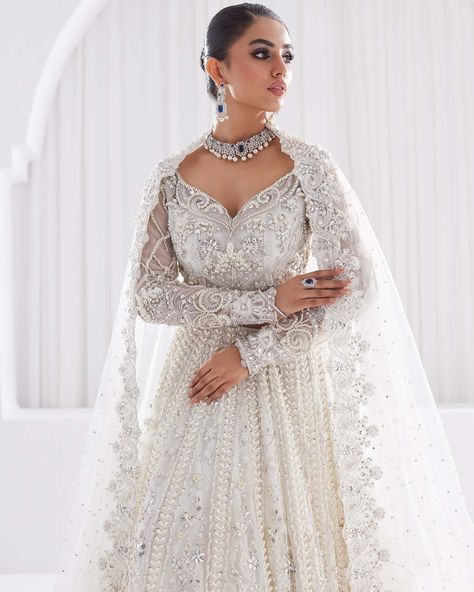 Serene white elegance unfolds in whispers of sheer layering, a symphony of delicacy. A vision to behold, a dream to wear. #pakistaniwedding #indianbridaldress #indianbridalwear #pakistanibridaldresses #pakistaniwedding #pakistanidresses #pakistaniclothing #pakistanidesignerwear #pakistanistyle #alifbymeem Pakistani White Bridal Dress, White Wedding Lengha, White Lehenga Bridal, White Pakistani Bridal Dress, White Pakistani Wedding Dress, White Bridal Saree, Aria Outfits, White Wedding Lehenga, White Indian Wedding Dress