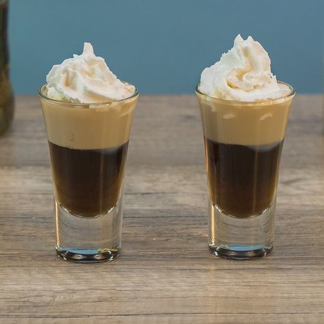 BANANA BREAD SHOOTER 3/4 oz. (22.5ml) Chocolate Liqueur 3/4 oz. (22.5ml) Banana Liqueur 1/2 oz. (15ml) Irish Cream Garnish: Whipped Cream PREPARATION 1. Add ice, chocolate liqueur and banana liqueur to shaking glass and combine well. Pour into shot glass. 2. Use a spoon to gently layer irish cream on top before finishing with whipped cream. DRINK RESPONSIBLY! (User Submitted by Brandon @ TipsyBartender.com) Holiday Shot Recipes, Amaretto Recipes, Tipsy Bartender Recipes, Drinking Shots, Layered Shots, Baileys Cocktails, Shooter Recipes, Bachelorette Party Drinks, Cocktail Shots