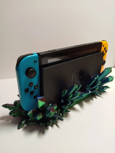 3D printed Nintendo Switch crystal dock shroud. They are specially designed to hold the Switch while in the dock and have cutouts to allow access to all ports and the rear panel for convenience. Switch Holder, Nintendo Switch Controller, Controller Holder, Switch Case, Nintendo Switch Case, Switch Accessories, Laser Projects, Future Room, Nintendo Switch Accessories