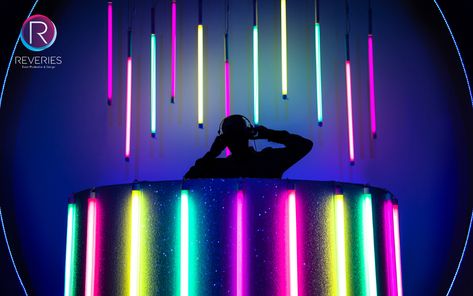 Custom made glittered curved DJ Booth with multi coloured neon encapsulate tubes for themed corporate party. #neonparty #ibizavibes #partydesign #eventdesign #setdesign #djbooth #events #reveriesevents Neon Dj Booth, Led Dj Booth, Cool Dj Booth, Dj Set Design, Festival Dj Booth, Futuristic Party Theme, Dj Booth Design, Futuristic Party, Dj Table