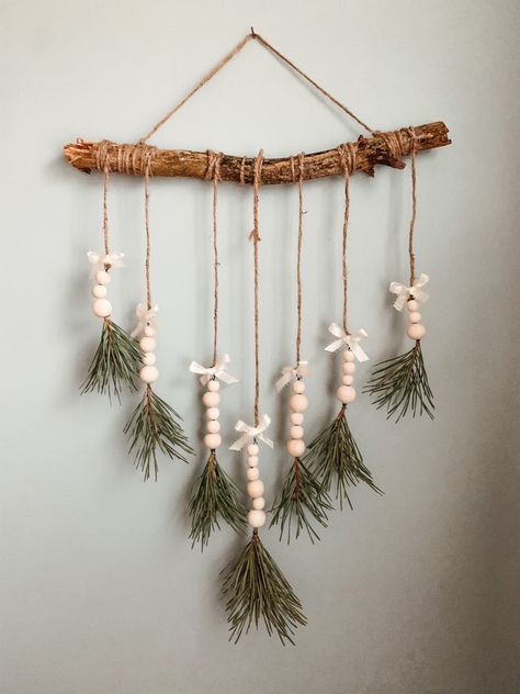 Evergreen tips, wooden balls, ribbon, twine and a stick Hanging Stick Decor, Stick Christmas Tree Branches, Stick Christmas Decorations, Mystical Crafts, Wrapped Sticks, Sales Ideas, Stick Christmas Tree, Christmas Sales, Window Decorations