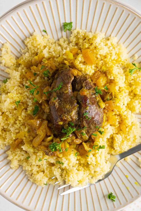 This Moroccan Lamb Shank Tagine originated in my father's hometown of Marrakech and is packed with flavors of garlic, preserved lemon and lamb. You will love the sauce this dish provides served with a fresh baguette or over a bed of couscous. Moroccan Lamb Shanks, Moroccan Lamb Tagine, Fresh Baguette, Moroccan Salad, Lamb Shank, Moroccan Lamb, Moroccan Mint Tea, Tagine Recipes, Beef Shank