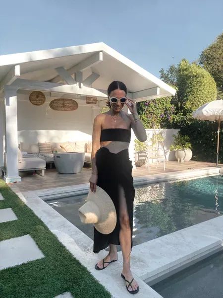 Pool day ready in this all black swim look. This black sarong coverup is my new go-to for at home pool days or when I am on vacay! I am obsessed with this crinkle bandeau suit and it pairs so well with this oversized hat and black sandals! To shop more of my summer looks and pool day fashion favorites, head to my LTK linked here. | swim, summer, bikini, coverup, style, outfit Black Sarong Outfit, Pool Day Outfit, Black Sarong, Black One Piece Bathing Suit, Inside Pool, Bathing Suit Outfits, Home Pool, Beach Vacation Style, Pool Dress