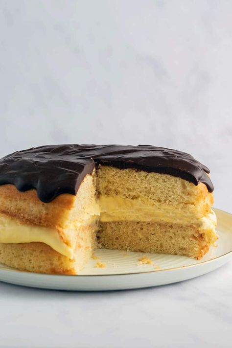 This keto Boston cream pie is a moist and fluffy vanilla cake layered with a low carb custard and topped with chocolate frosting! No sugar and no grains needed. Boston Creme Pie, Boston Cream Pie Recipe, Creme Pie, Porcelain Cake Stand, Porcelain Cake, Boston Cream Pie, Leftover Cake, Cream Pie Recipes, Boston Cream