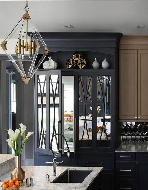 A display shelf is fixed above black mirrored refrigerator doors complementing black freezer drawers finished with satin nickel pulls. Farmhouse Kitchen Lighting, Hallway Art, Decor Hallway, Home Luxury, Kitchen Remodel Idea, Cabinet Design, Aged Brass, Beautiful Kitchens, Contemporary Kitchen