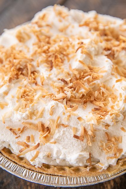 Old Fashioned Coconut Cream Pie - perfect ending to any meal! t is hands-down the best coconut pie we've ever eaten. I took this to a potluck and it was gone in a flash. Coconut, sugar, cornstarch, coconut milk, half-and-half, eggs, salt, vanilla, pie crust and fresh whipped cream. Seriously delicious! #pie #coconutcreampie #dessert Old Fashioned Coconut Cream Pie, Coconut Creme Pie, Pie Coconut, Vanilla Pie, Coconut Pie Recipe, Whipped Cream Topping, Chocolate Peanut Butter Desserts, Coconut Cream Pie Recipes, Coconut Pudding