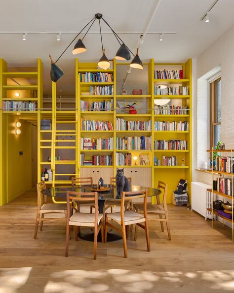 A Yellow Floor-to-Ceiling Library Wall Brightens Up This SoHo Loft - Dwell Table Pendant Lighting, Modern Dining Rooms, Staircase Outdoor, Farmhouse Scandinavian, Soho Loft, Plant Kitchen, Light Hardwood, Light Hardwood Floors, Library Wall