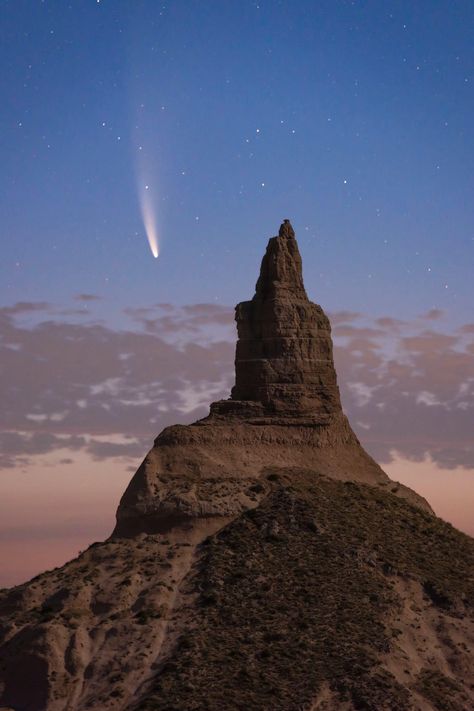 Comet Neowise in the sky above Chimney Rock, Nebraska Chimney Rock Nebraska, Chimney Rock, The Comet, Its A Mans World, Dark Matter, Dark Skies, The Night Sky, Mans World, Nature Travel