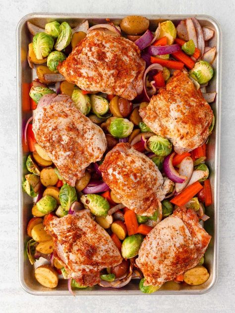 Whip up this Chicken Thigh Tray Bake for a fuss-free meal that's loaded with flavor! With juicy chicken thighs, colorful veggies and a sprinkling of seasonings, everything roasts on one sheet pan for maximum flavor and easy cleanup! Chicken Tray Bake Recipes, Traybake Dinner, Curried Rice Salad, Vegetable Bake Recipes, Juicy Chicken Thighs, Sheet Pan Meals Chicken, Chicken Tray Bake, Cubed Sweet Potatoes, Tray Bake Recipes