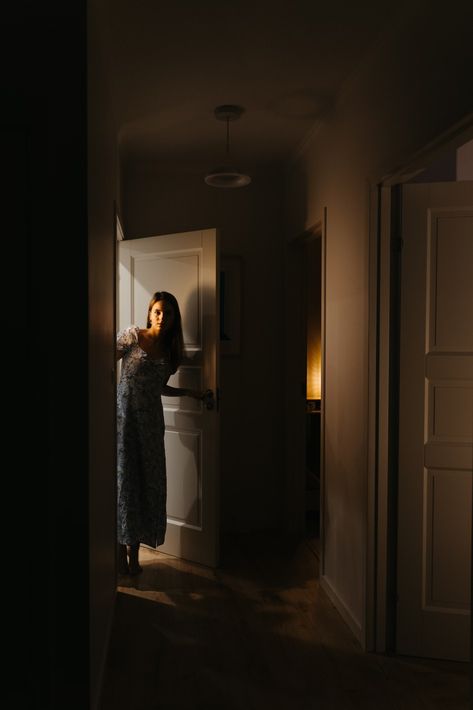 A woman is standing in a dark hallway photo – Free At home Image on Unsplash House Photography Interior, Hallway Poses, Woman Opening Door, Hallway Photoshoot, Aesthetic Photoshoot Ideas At Home, Hallway Photography, Door Photoshoot, Hallway Dark, Cinematography Ideas