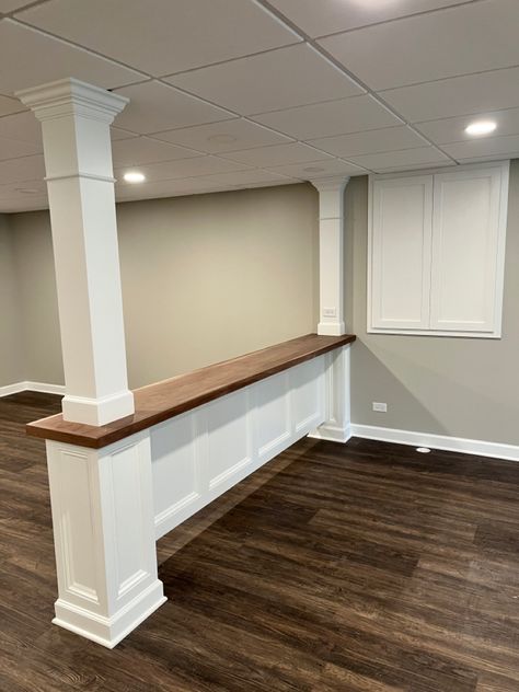 Basement Post Ideas Columns, Finished Basement With Support Poles, Basement Couch Bar, Table Around Basement Pole, Basement Bar With Support Post, Pillar In Middle Of Living Room, Basement Ideas With Poles, Basement Bar Seating Behind Couch, Bar Wall Tv