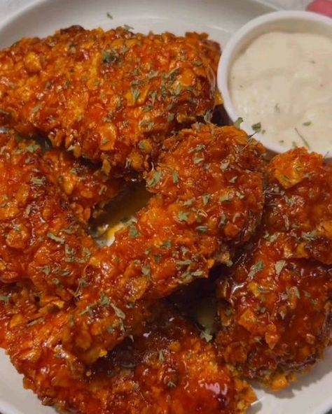 Daily Recipes on Instagram: "Honey Buffalo Chicken Tenders. High protein and low fat dinner by @vannisaterala

Ingredients
2 chicken breasts
2 cups crushed cornflakes
1 tbsp salt
1 tbsp cayenne
2 tbsp paprika
1 tbsp garlic powder 
1 tsp black pepper
1 egg
1/2 cup buffalo sauce 

Sauce
1/2 cup buffalo sauce
1 tbsp honey 

Directions
1. Crush your cornflakes in a bag with rolling pins or a can.
2. Mix the corn flakes with 1/2 tbsp salt and paprika. 
3. Cut the chicken breasts into strips and season with salt, cayenne, paprika, black pepper and garlic powder.
4. Whisk the egg with buffalo sauce. 
5. Dip your chicken into the egg mixture and coat in crushed cornflakes. Continue until all the chicken is coated.
6. Air fry at 375-400F for 18-20 minutes depending on the size of your tenders. Keep Honey Buffalo Chicken, Buffalo Chicken Tenders, Low Fat Dinner, Daily Recipes, Rolling Pins, Corn Flakes, Buffalo Sauce, Air Fry, Chicken Tenders