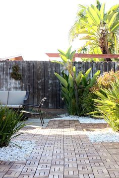 backyard patio with ikea PLATTA decking Deck Tiles Over Gravel, Ikea Patio Tiles, Ikea Decking Tiles, Ikea Decking, Ikea Deck Tiles, Ikea Deck, Outdoor Checkers, Ikea Garden, White Rocks