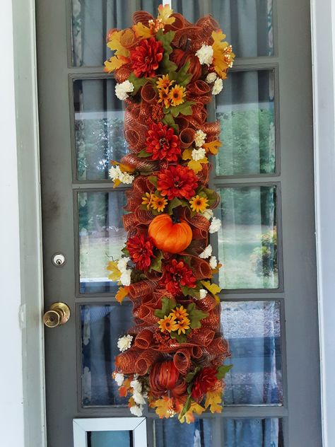 A full yard of mesh, pumpkins, fall flowers with a sprinkle of fall leaves. Yardstick Wreath, Fall Centerpieces Diy, Stick Wreath, Fall Mesh Wreaths, Yard Sticks, Swag Ideas, Decor Business, Teardrop Swag, Fall Swags