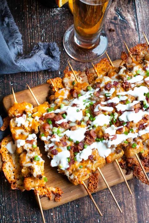 Tater Tot Skewers loaded up with taco spiced ground beef, melted cheese, bacon and drizzled in sour cream. This easy appetizer is so good, you are gonna make this all the time! #cookswithcocktails #appetizer #tatertots #easyappetizer #gameday Tator Tot Skewer, Tater Tot Bar, Tostitos Scoops Appetizers, Tater Tot Skewers, Game Day Food Ideas, Tater Tot Appetizers, Cauliflower Tater Tots, Super Bowl Menu, Taco Spice