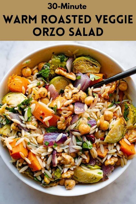 Vegan Roasted Veggie Orzo Salad is a healthy, budget-friendly meal. Roasted chickpeas add plant-based protein to this warm fall salad. Roasted Veggies And Orzo, Orzo And Roasted Vegetables, Thanksgiving Orzo Salad, Orzo Fall Salad, Orzo Salad Vegan, Roasted Veggie Orzo Salad, Roasted Veggie Orzo, Veggie Orzo Salad, Vegetarian Orzo