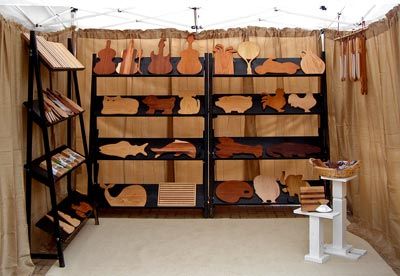 Improved Art Show Booth:  Fantastic article on booth improvement!  Replace tables with shelves or pedestals, use walls, use height, declutter. Craft Show Walls, Art Show Booth, Angled Shelves, Art Festival Booth, Craft Fair Vendor, Art Booth, Art Fair Booth, Craft Fair Booth Display, Craft Show Booths