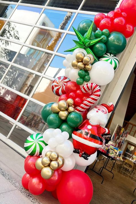 Celebrate the season with this festive Christmas balloon garland, featuring a lively mix of red, green, white, and gold balloons. Complete with candy cane accents, peppermint swirls, and a jolly Santa balloon, this setup is perfect for adding holiday cheer to any event. Whether used as a fun photo backdrop or eye-catching entrance decor, this balloon arrangement is sure to bring a touch of magic and joy to your holiday party! Perfect for Christmas-themed events and family gatherings. Christmas Grab And Go Balloon Garland, Santa Baby Balloon Arch, Christmas Garland Balloons, Christmas Balloon Photo Backdrop, Christmas Photo Op Backdrop, Santa Event Ideas, Christmas Balloon Garland Ideas, Christmas Balloon Columns, Christmas Balloon Backdrop