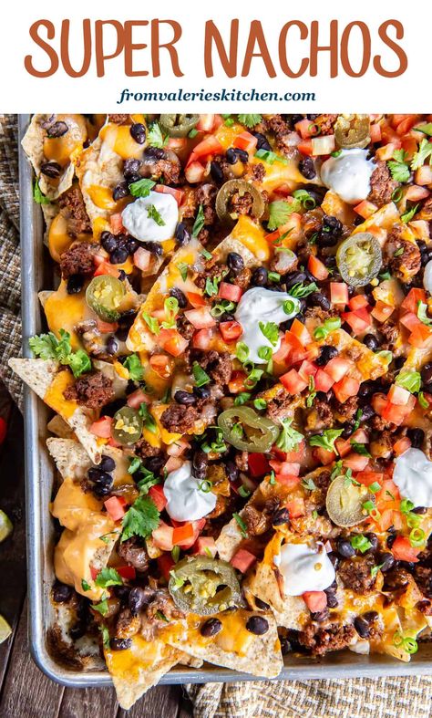 These sheet pan Super Nachos are loaded with ground beef, black beans, homemade nacho cheese sauce, and plenty of freshly shreddded cheese. Just pile on your favorite toppings and dig in! Seasoning For Nacho Meat, Best Loaded Nachos Recipe, Cookie Sheet Nachos, Loaded Sheet Pan Nachos, Nacho Plate Ideas, Grilled Nachos On Grill, Nacho Platter Recipes, Nacho Dinner Recipes, Fully Loaded Nachos