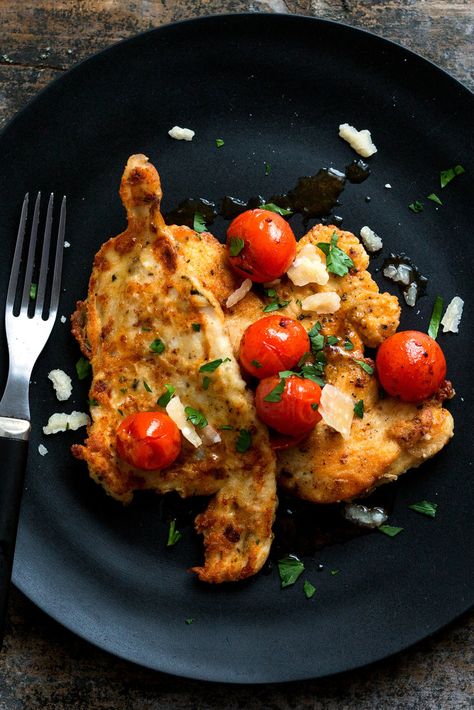 NYT Cooking: This is a summery dish to make in the middle of a cold winter (or early spring), but you can find decent cherry tomatoes even now, from Florida or from Mexico. I marinate the breasts in lemon juice, olive oil, garlic and rosemary before I pound them. This makes them very flavorful, a great savory contrast to the sweet tomato topping. Chicken With Cherry Tomatoes Recipe, Chicken With Cherry Tomatoes, Lemon And Garlic Chicken, New York Times Recipes, Nyt Recipes, Cherry Tomato Recipes, Tomatoes Recipe, Lemon Garlic Chicken, Healthy Weeknight Dinners