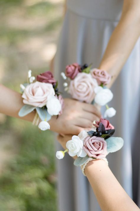 The elegant wrist corsages are made up of artificial dusty rose foam rose, mauve foam rose bud, ivory silk ranunculus and dusty rose foam rose, accented with pearls, Elm leaves, and flocked silver dollar eucalyptus.The corsage wristlet is filled with dusty rose, mauve and ivory details! #wrist_corsage #corsage_bracelet #corsage_wristbands #wedding_accessories French Weddings, Wrist Corsage Bracelet, Weddings Country, Wedding Corsages, Wrist Corsages, Mauve Wedding, Rose Corsage, Wedding Flower Packages, Circus Circus