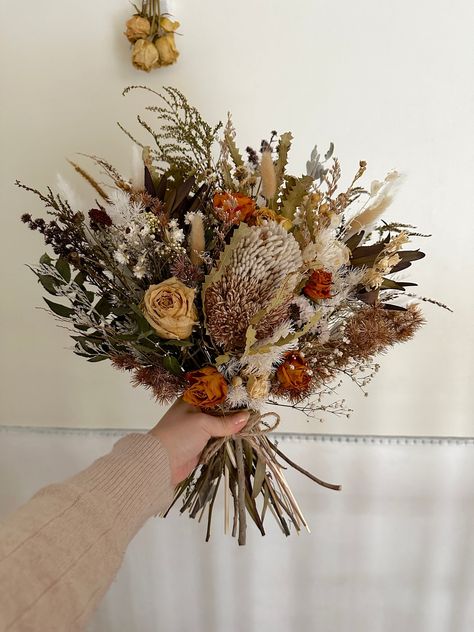 RTS from Sydney. How glorious are these fall theme bouquet featuring lots of detailing. I have used a range of dried and preserved flower and greenery that combines all the natives we love like gum, tea tree, banksia, protea, palm leave and bunny tails etc also A class dried and preserved roses. All foliage used are dried or preserved and can last for a year as long as kept out of direct sunlight and in a well ventilated space. I have used a velvet burnt orange tie for the perfect finish. Size measures 50cm long and 40cm in width. If you wish I can also make boutonnière, hair accessories, pins, smaller bouquet etc. Did you know this bouquet will last a few years if stored well? No water required, simply keep them in a cool room with good airflow and without direct sunlight. ' ❥* INTERNATIO Sage Eucalyptus, Eucalyptus Wedding Bouquet, Australian Natives, Winter Bouquet, Green Sage, Dried Bouquet, Bunny Tails, Preserved Roses, Orange Tie