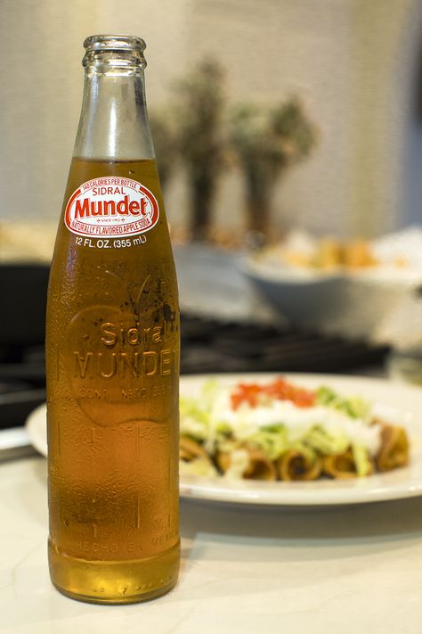 | | Sidral Munet Red Apple with Flautas | |  Flautas, Mexican Food, Mexican Dishes, Jarritos, Soft Drink, Mexican Soda, Fruit Flavored Soda, Glass Bottle, Iconic Beverage,  Soda Mixer, Soda in a Glass Bottle, Real Sugar, Cane Sugar, Made in Mexico, Mexico, Mexican, Natural Flavor Soda, 100 percent natural sugar, Mexican food, cocktail recipes, Mexican, Naturally Flavored, Bright, Colored Soda, Fun Soda, Colorful Sodas, Iconic Mexican Soda. Soda In Glass Bottles, Mexican Soda, Soda Ads, Bottled Drinks, Restaurant Graphics, Recipes Mexican, Food Mexican, Cane Sugar, Fruit Drinks