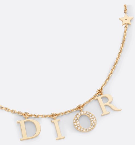 The Dio(r)evolution necklace is both elegant and timeless. The 'DIOR' letters are suspended on a gold-finish metal chain, and the letter 'O' is in a pavé of white crystals to add shimmer to the neck. The effortless style can be worn with other creations from the Dio(r)evolution line.. Dior Letter Necklace, Dior Necklace Gold, Sweet 16 Jewelry, Dior Necklace, Pretty Jewelry Necklaces, Dior Jewelry, Bags Designer Fashion, White Crystals, Expensive Jewelry