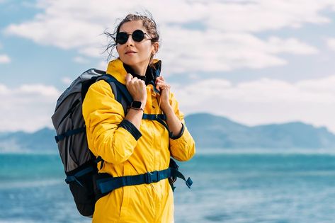 Portrait of a female traveler on the background of the sea. The concept of adventure, travel and hiking. A female tourist enjoys a beautiful landscape during a hike. Portrait of a tourist by the sea Sea Background, A Sea, Female Travel, By The Sea, Beautiful Landscapes, Adventure Travel, The Sea, Hiking, Travel