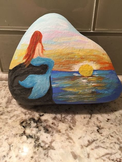 Mermaid Watching Sunset painted rock Acrylic Painting Rocks, Beach Sunset Painting, Watching Sunset, Dengeki Daisy, Art Pierre, Stone Art Painting, Seashell Painting, Mermaid Painting, Painted Rocks Craft