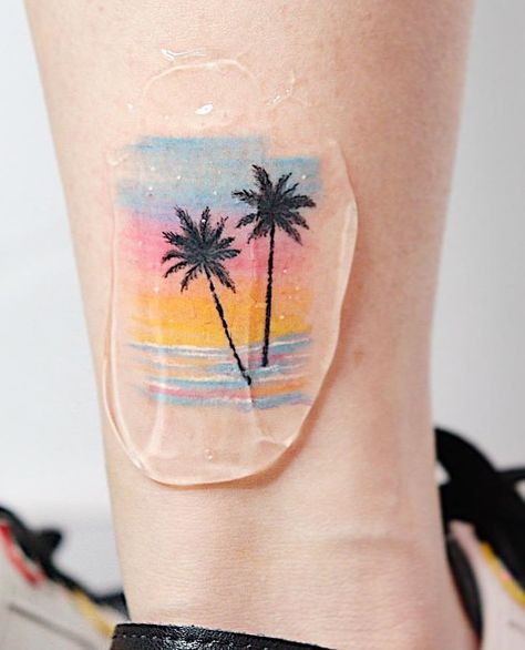 13 Palm Tree Tattoos That Will Inspire You Palm Tree Sunrise Tattoo, Palm Trees Sunset Tattoo, Colorful Beach Tattoos For Women, Pine Tree And Palm Tree Tattoo, Best Friend Palm Tree Tattoo, Palm Tree Hibiscus Tattoo, Color Beach Tattoo, Palm Tree And Sunset Tattoo, Double Palm Tree Tattoo