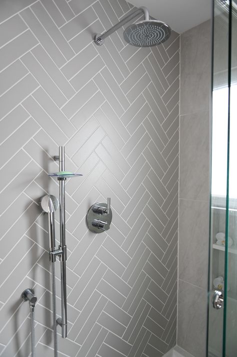 Herringbone Shower Tile Accent Wall, Grey Subway Tile Shower Ideas, White And Grey Bathroom Tile, Grey Herringbone Shower Tile, Grey Herringbone Bathroom Tiles, Chevron Subway Tile Shower Wall, Hering Bone Tile Bathroom Wall, Subway Tile Chevron, Grey Herringbone Tile Bathroom