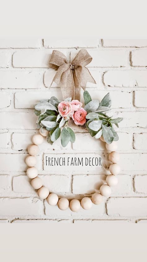 Large wood beads strung onto a hoop wreath mixed with lamb's ear and florals Wood Beads Wreaths, Beaded Wreath With Flowers, Wood Bead Floral Wreath, Wood Bead Wreath Diy Spring, Wood Beads Wreath, Bead Hoop Wreath, Ring Wreaths Floral, Dollar Tree Wooden Bead Wreath, Large Bead Crafts