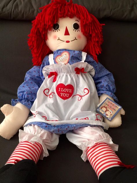 TOY: 1915 - Raggedy Ann is a character created by American writer Johnny Gruelle in a series of books he wrote and illustrated for young children. Raggedy Ann is a rag doll with red yarn for hair and has a triangle nose Gruelle received US Patent D47789 for his Raggedy Ann doll in 1915. The character was created in 1915 as a doll, and was introduced to the public in the 1918 book Raggedy Ann Stories. When a doll was marketed with the book, the concept had great success. [Raggedy Ann 100 year edi Raggedy Ann Costume, Annabelle Doll, Raggedy Doll, Raggedy Ann Doll, Ann Doll, Costume For Halloween, Raggedy Ann And Andy, Red Yarn, Rag Dolls