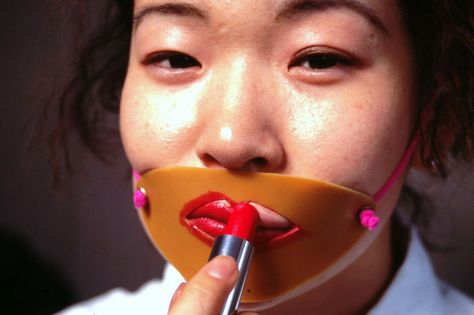 woman applying lipstick with face man-and-woman-using-a-selfie-stick Be Still Tattoo, Japanese Inventions, Lipstick Guide, Japanese Trends, Weird Inventions, Thought Experiment, Burning Man Fashion, Cool Inventions, Selfie Stick