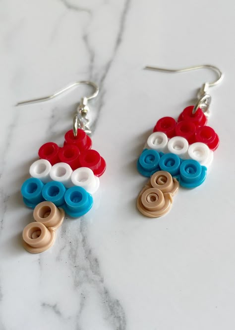 Handmade Rocket Pop earrings made with perler fusion beads. Finished off with a sterling silver hook earring. Circle Perler Beads Ideas, Fun Fusion Beads Ideas, Popsicle Perler Bead Patterns, Pearler Bead Ideas Preppy, Cookie Monster Perler Beads, 4th Of July Perler Beads, Melting Bead Earrings, Cute Perler Bead Earrings, Peeler Beads Earrings