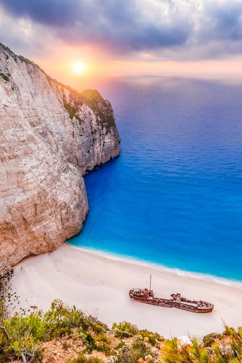 During your stay at Paliokaliva village, don't miss the chance to visit Navagio beach, because after all, all you need is sand, sun, turquoise waters and a ship fable ⚓ 🕵️‍♀️ Navagio Beach, Greek Islands Vacation, Zakynthos Greece, Places In Europe, Greek Island, Menorca, Shipwreck, Beautiful Places To Travel, Greece Travel