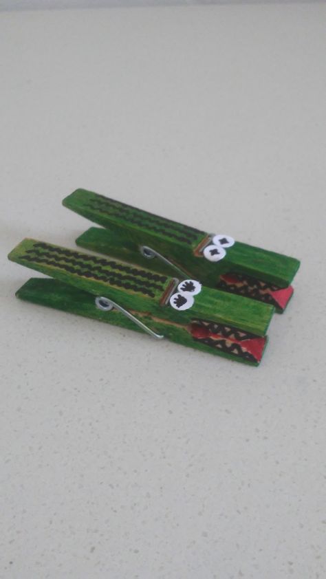 Green, red, and black markers help you transform clothespins into cute little alligators. The eyes are made using white paper and a hole punch. They are perfect as simple toys the kids can make themselves or to use as decorative clips. Alligator Craft, Alligator Crafts, Simple Toys, Spring Crafts For Kids, Hole Puncher, Clothes Pin Crafts, Kids' Crafts, Toy Craft, Clothes Crafts