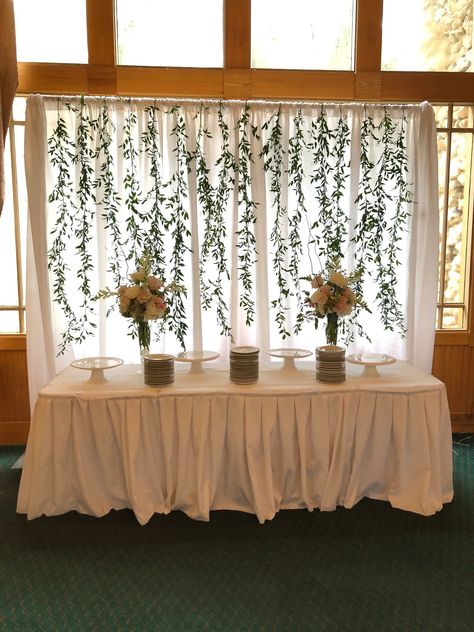 Italian ruscus greenery backdrop for a wedding or shower. Ruscus Greenery Wedding, Backdrop For Dessert Table, Wedding Ribbon Backdrop, Diy Head Table, Italian Ruscus Greenery, Eucalyptus Backdrop, Curtain Backdrop Wedding, Ruscus Greenery, Greek Night