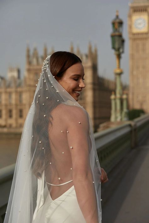 The Eleanor veil is an ivory single tier veil and is a modern take on the traditional bridal veil. It features stunning pearls, which are scattered onto the tulle from head to the bottom, with pearls placed closer together on the top. The pearls are attached to the tulle with a modern rivet style fastening giving the veil a luxurious minimalist feel. The Eleanor veil is made from a soft, floaty tulle and attached to a silver metal comb. The Eleanor veil comes in two lengths, 2m & 3m. Width: 160cm(2m veil photographed) Veil come beautifully packaged in a satin bag. Veil Attached To Dress, Pearl Wedding Veil, Vowel Renewal, Comb Veil, Bridal Clutch Bag, Pearl Veil, Veil Accessories, Silver Headband, Metal Comb