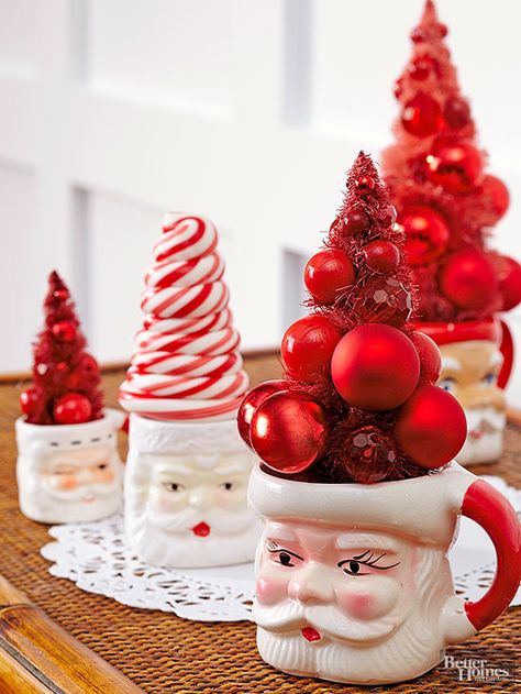 Santa mugs aren't just for hot cocoa and eggnog. Top off your collection with mini Christmas trees of all kinds -- sparkly, ornamented, even candy cane! Purchase them on the cheap at your local home goods store.   / Easy Holiday Decorations, Mini Christmas Trees, Retro Christmas Decorations, Vintage Christmas Crafts, Santa Mug, Party Crafts, Home Goods Store, Santa Mugs, Christmas Bedroom